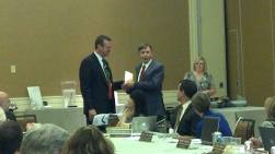 Outgoing board member Tom Crowe is recognized by Whitney Cunningham